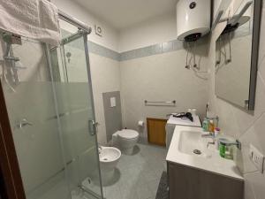 a bathroom with a shower and a toilet and a sink at Daniel's in Isola delle Femmine +32 photos