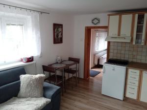 a kitchen and living room with a couch and a table at Apartmán Jarka in Tatranska Strba
