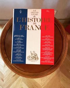 two books sitting on top of a wooden table at Château Doré les Tours - Appartement Renard in Montfaucon +30 photos