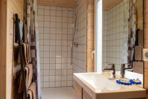 a bathroom with a sink and a shower at 2bedroom house in Mērsrags +41 photos