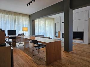 a living room with a large wooden table and chairs at Lycabettus Urban Elegance by YHA in Athens