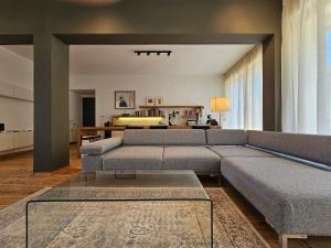 a living room with a couch and a table at Lycabettus Urban Elegance by YHA in Athens