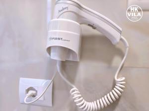 a white hair dryer hanging on a wall at Vila HK in Krujë