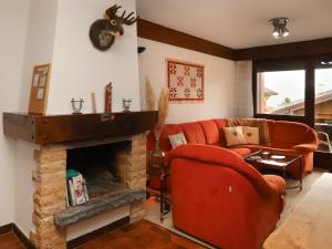 a living room with a couch and a fireplace at Apartment Lichen 4 by Interhome in Verbier