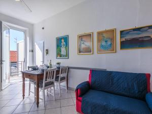 a living room with a couch and a table at Apartment Maestrale by Interhome in Marina di Cecina