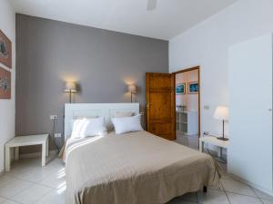 a bedroom with a large bed with two pillows at Apartment Maestrale by Interhome in Marina di Cecina