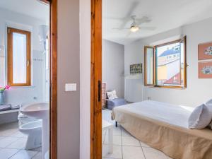 a bedroom with a bed and a bathroom with a sink at Apartment Maestrale by Interhome in Marina di Cecina +30 photos