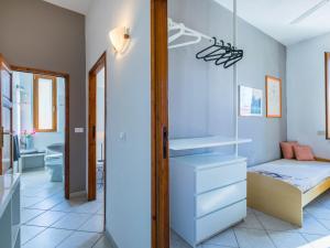a small bedroom with a bed and a bathroom at Apartment Maestrale by Interhome in Marina di Cecina