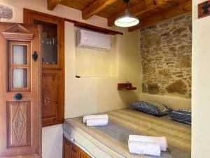 a room with a bed with towels on it at Symi Uptown Indigo in Symi +75 photos