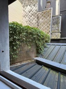 a wooden bench sitting outside of a house at Studio Cosy Beauvoisine in Rouen