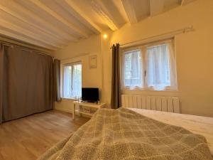 a bedroom with a bed and a computer on a table at Studio Cosy Beauvoisine in Rouen