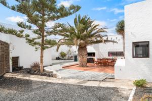 a courtyard with two palm trees in a house at Playa Marina Eco Beach Villa in Arrieta