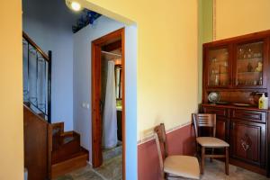 a room with a staircase and a chair and a mirror at Symi Uptown Indigo in Symi