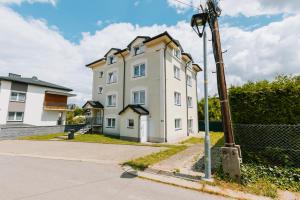 a white building on the side of a street at Apartamenty Krzywa in Krosno