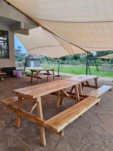 a group of picnic tables with an umbrella at Jsons executive suites in Nairobi