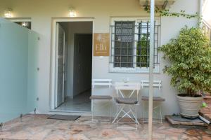 a table and chairs in front of a building at Ella apartments in Parga