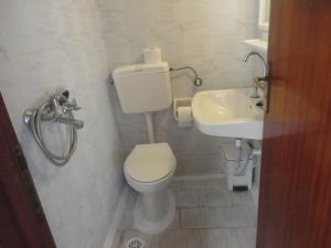 a bathroom with a toilet and a sink at Spamandos Rooms in Palaiochora