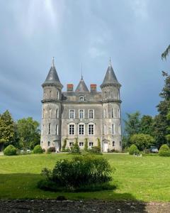 an old castle in a field of grass at Château Doré les Tours - Appartement Renard in Montfaucon