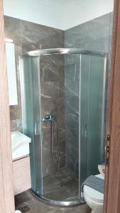 a shower with a glass door in a bathroom at Sea La Vie Beach House in Petra