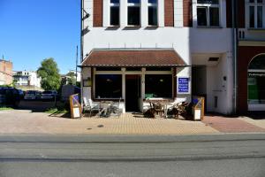 a table and chairs sitting outside of a building at Am Schloss 108 in Schwerin +6 photos