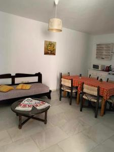 a living room with a table and a dining room at Sissi Mare Apartments in Sissi