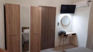 a room with a door and a mirror and a bed at Sea La Vie Beach House in Petra