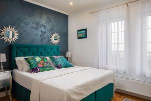 a bedroom with a bed with a green headboard at Villa Zvonimir in Klis +51 photos