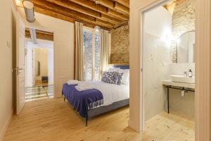 a bedroom with a bed and a bathroom with a sink at Palacio Vegafuente by Caleta Homes in Málaga