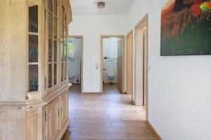 a hallway with a toilet and a painting on the wall at Sport Rees- Ferienwohnung Ulrich in Hofsgrund +27 photos