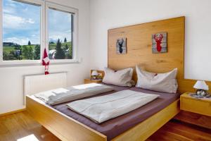 a bedroom with a bed with two pillows on it at Sport Rees- Ferienwohnung Ulrich in Hofsgrund