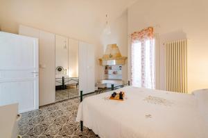 a bedroom with a white bed with two figurines on it at Casa Vacanze L'Aspidistra - Happy Rentals in Rutigliano +10 photos