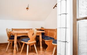 a dining room with a wooden table and chairs at Ferienwohnung Mit Bergpanorama in Hopfgarten im Brixental