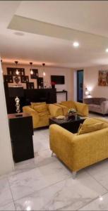 a living room with yellow couches and a couch at Palazzo Firenze in Naples