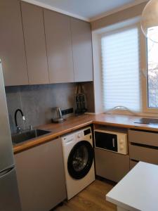 a kitchen with a washing machine and a sink at Муканова 6 in Karagandy