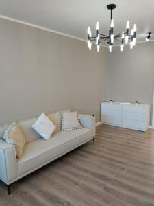 a living room with a couch and a table at Муканова 6 in Karagandy