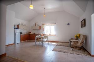 a kitchen with a table and a refrigerator at Agroturystyka Mazury u Basi in Łoje