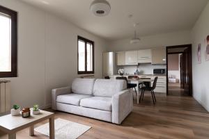 a living room with a white couch and a table at Casa vacanze Il Pescheto in Concesio +12 photos