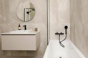 a bathroom with a white sink and a mirror at Bob W Tallinn Kesklinn in Tallinn