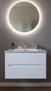 a bathroom with a white sink and a mirror at Casa vacanze Il Pescheto in Concesio