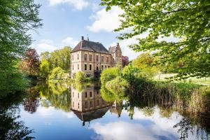 an old building reflected in the water of a lake at Boshuis Dreamstay Gorssel in Gorssel