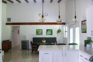 a kitchen and dining room with white cabinets and a table at Chateau Mariposa in Spring Hill