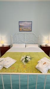 a bedroom with a bed with flowers on it at A casa di Iole in Fiumicino