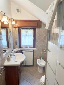 a bathroom with a sink and a toilet at A casa di Iole in Fiumicino +53 photos