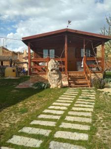 a log cabin with a pathway leading to the front porch at Apartamento El Paso in Fuentelisendo