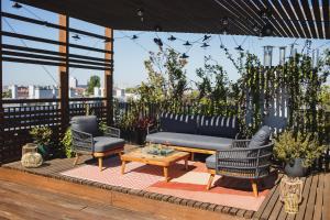 a patio with a couch and chairs and a table at The Circus Apartments in Berlin