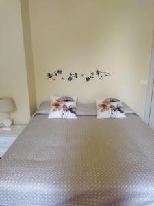 a bedroom with a bed with two pillows on it at Villa Fontana in Capannori