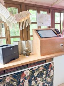a desk with a printer on top of a counter at Villa Fantasia Budget Boutique Hotel in Füssen