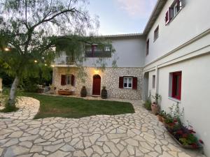 a courtyard of a house with a stone driveway at Stone House In Katouna With Garden in Katouna