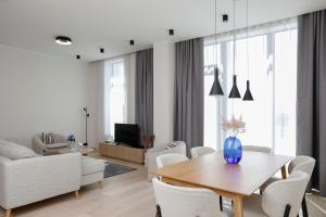 a white living room with a table and chairs at Bob W Tallinn Kesklinn in Tallinn +107 photos