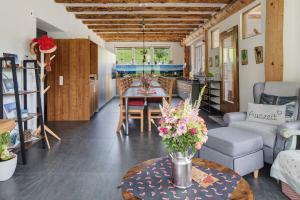 a living room with a table with flowers on it at Fewo Schwarzwaldflair mit Eventraum in Hofsgrund